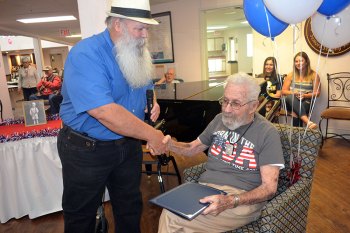 Kings County Supervisor Joe Neves presents a county proclamation to 103-year-old Jack Schwartz during his birthday celebration April 28 at The Remington.